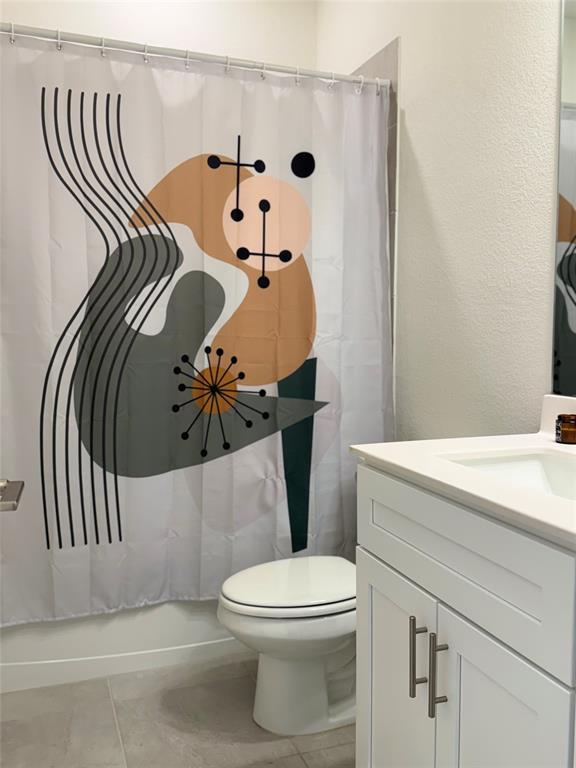 1122 Silverthorne Trail Justin, TX 76247 - Photo 14 of 19 Full bathroom featuring vanity, light tile patterned floors, and shower / bathtub combination with curtain