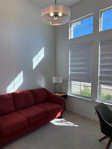 a living room with furniture a window and a chandelier