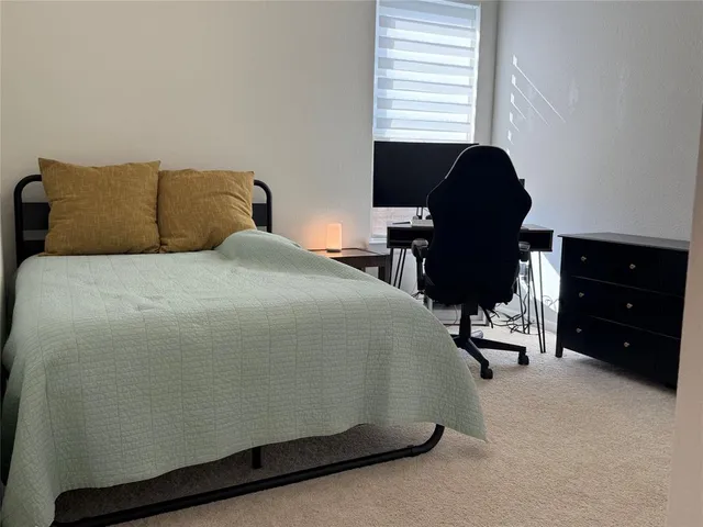 a bedroom with a bed and a desk