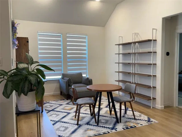 a view of a livingroom with furniture and a potted plant