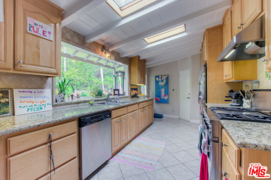 397 Fordyce Road Los Angeles, CA 90049 - Photo 6 of 9 a kitchen with stainless steel appliances granite countertop a sink and a counter