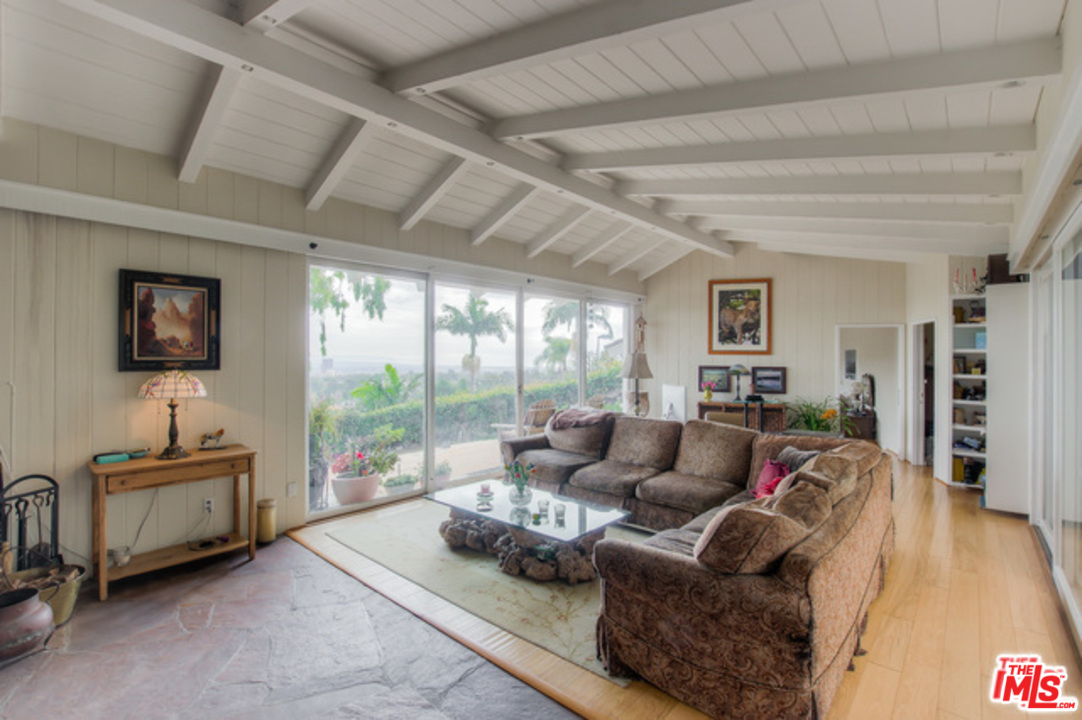 397 Fordyce Road Los Angeles, CA 90049 - Photo 7 of 9 a living room with furniture and a flat screen tv