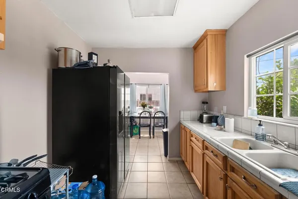 a kitchen with granite countertop a sink stove and cabinets
