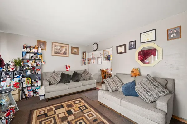 a living room with furniture and painting on the wall