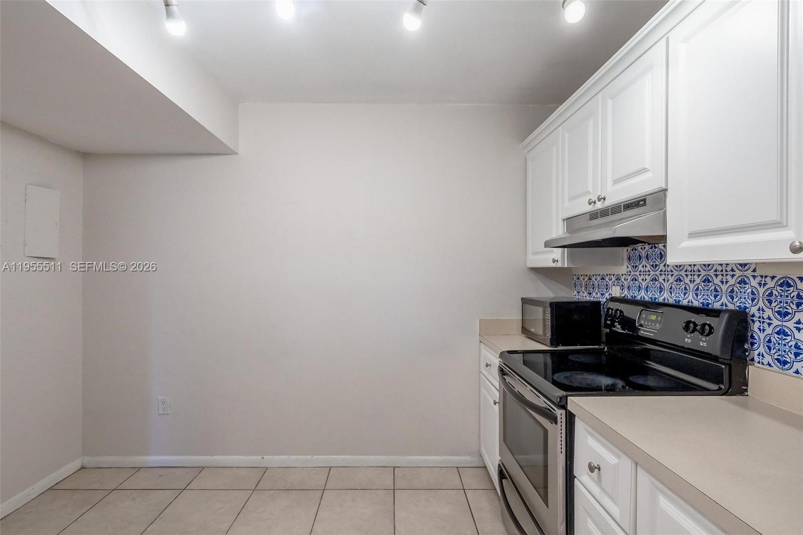 711 North Pine Island Road, Unit 410 Plantation, FL 33324 - Photo 11 of 45 a kitchen with a sink and cabinets