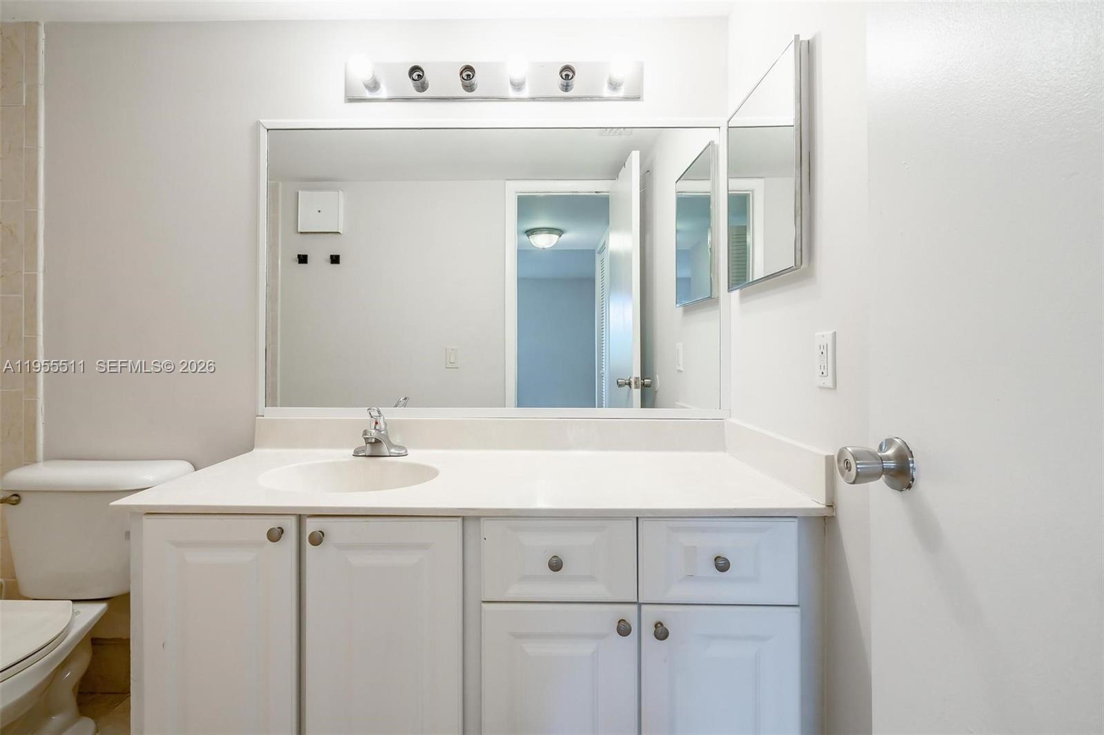 711 North Pine Island Road, Unit 410 Plantation, FL 33324 - Photo 17 of 45 a bathroom with a sink vanity and a mirror
