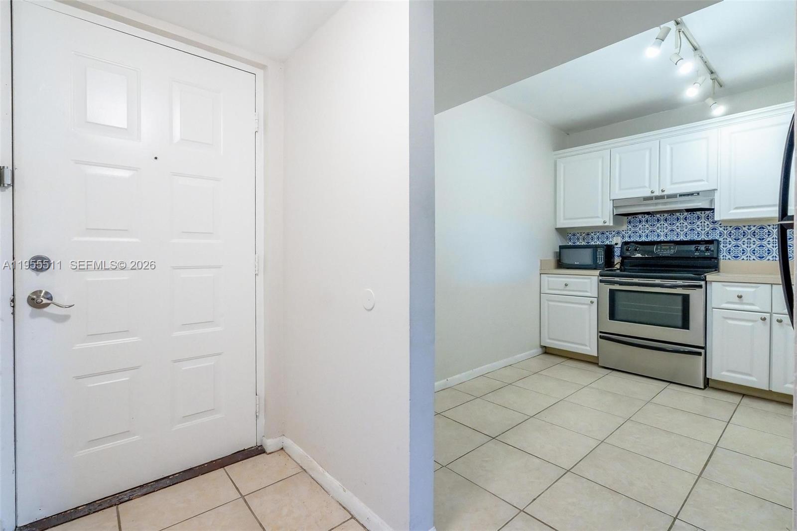 711 North Pine Island Road, Unit 410 Plantation, FL 33324 - Photo 22 of 45 a kitchen with white cabinets and white appliances