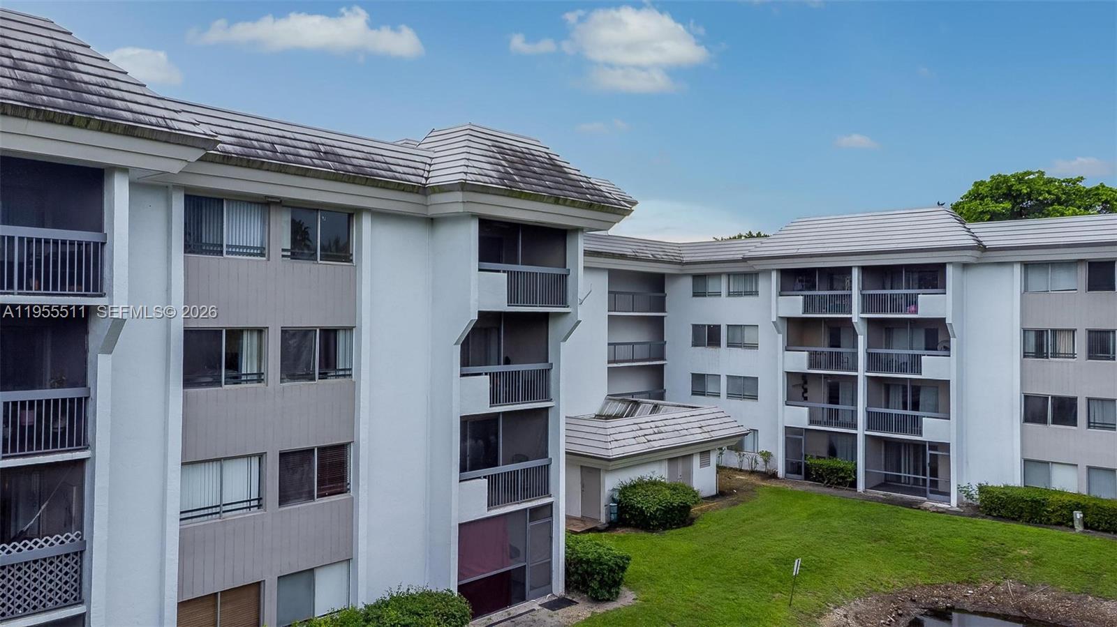 711 North Pine Island Road, Unit 410 Plantation, FL 33324 - Photo 43 of 45 a front view of a building with a garden