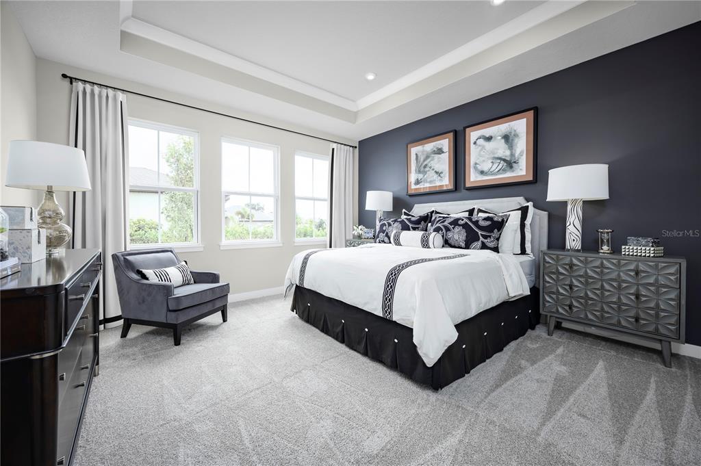 22174 Pine Grove Loop Leesburg, FL 34748 - Photo 6 of 8 a spacious bedroom with a bed and a couch