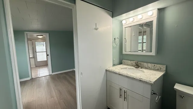 a bathroom with a glass shower door