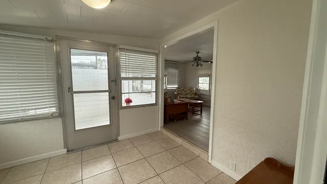a room with a window and a kitchen