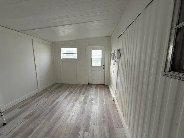 a view of hallway with wooden floor