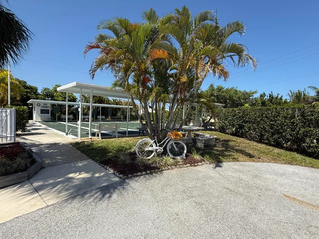 a view of a terrace with a bench and potted plants