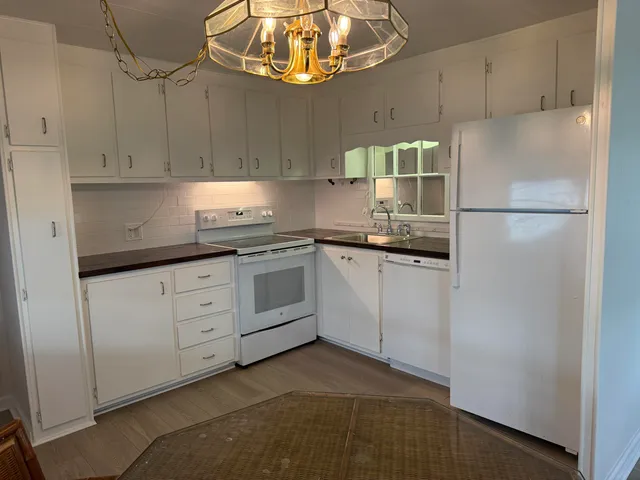 a kitchen with cabinets and stainless steel appliances