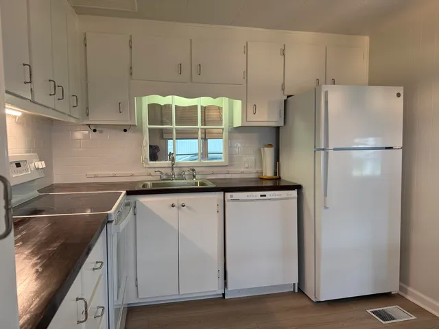 a kitchen with stainless steel appliances granite countertop a refrigerator sink and cabinets