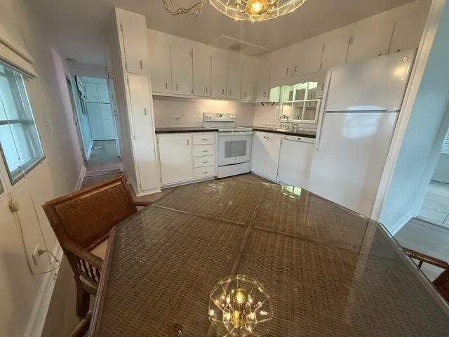 a kitchen with stainless steel appliances a refrigerator sink and cabinets