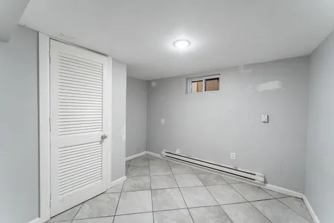 a living room with furniture a flat screen tv and gym equipment