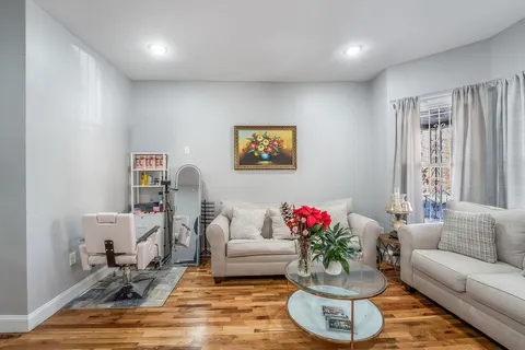 a living room with furniture flowerpot and a window