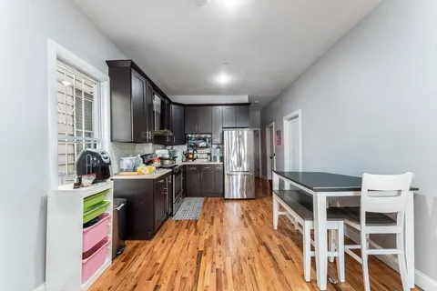 a kitchen with kitchen island granite countertop lots of counter top space and stainless steel appliances