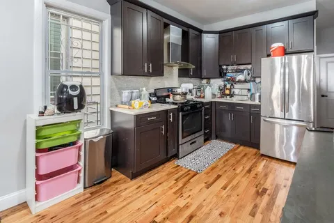 a kitchen with stainless steel appliances granite countertop a refrigerator a stove top oven a sink and dishwasher
