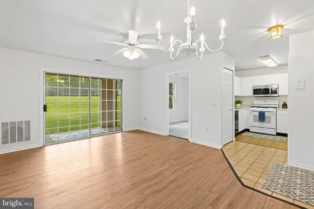 a kitchen with cabinets stainless steel appliances and a counter space