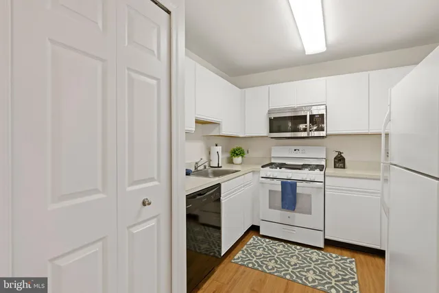 a kitchen with cabinets appliances and a sink