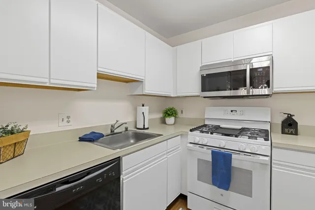 a kitchen with a refrigerator stove and microwave