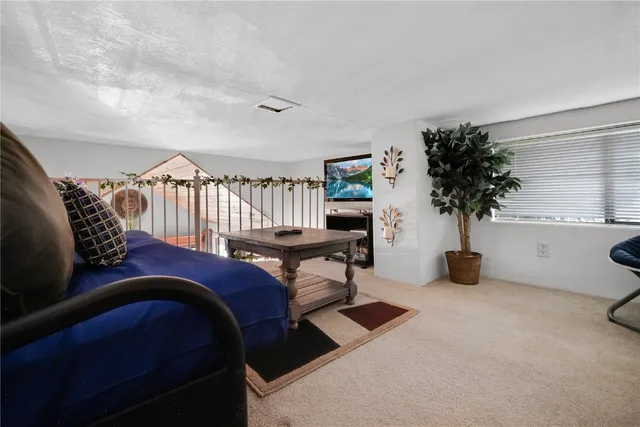 a bedroom with furniture and a potted plant