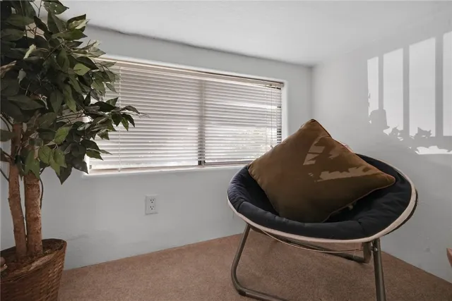 a vase of flowers sitting next to a window