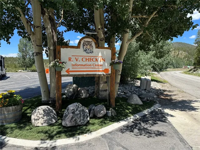a view of a sign board with trees