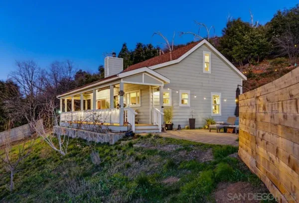 a front view of house with yard and outdoor seating