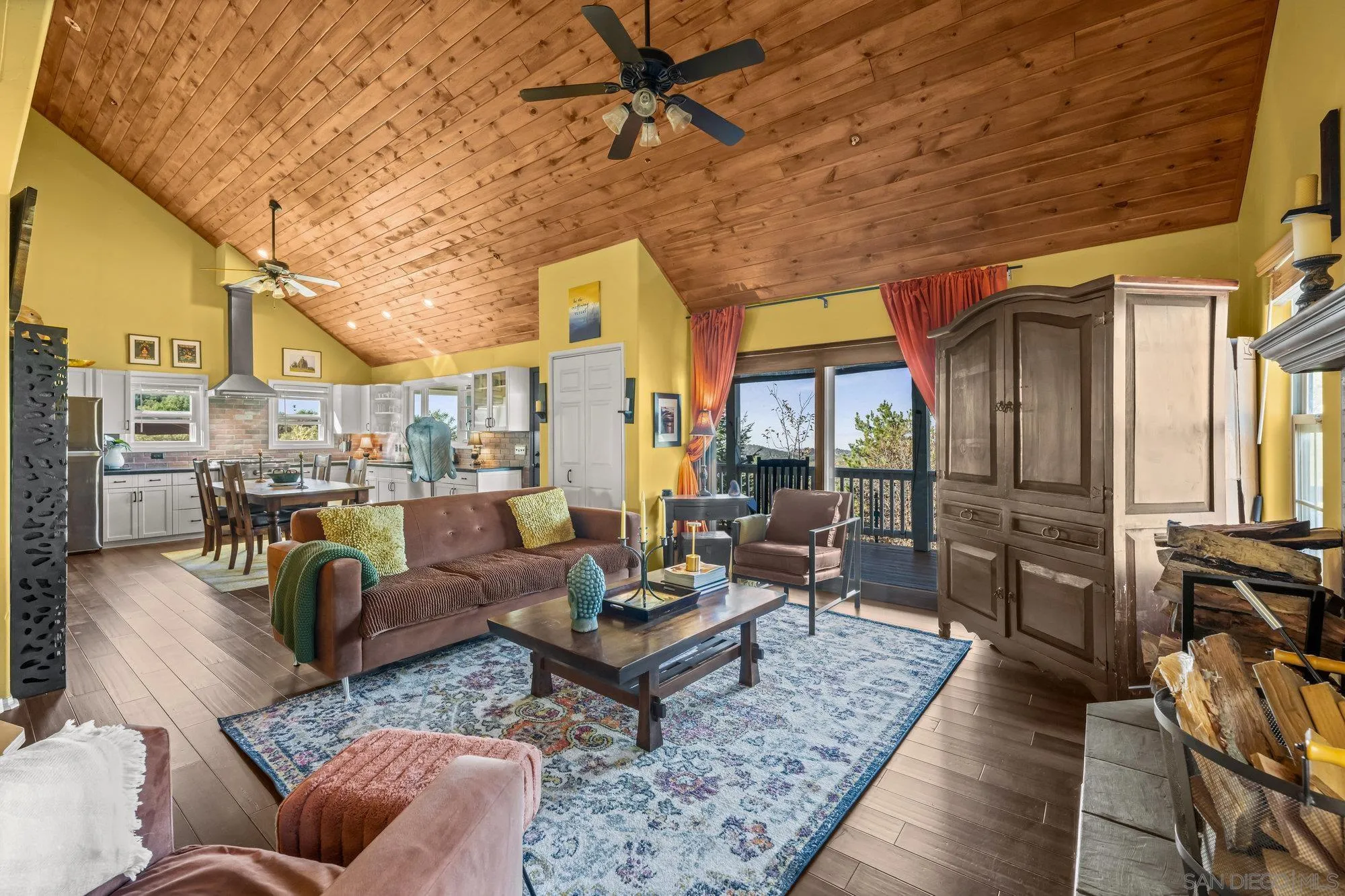 5058 Acorn Patch Road Julian, CA 92036 - Photo 13 of 32 a living room with furniture a rug kitchen view and a large window