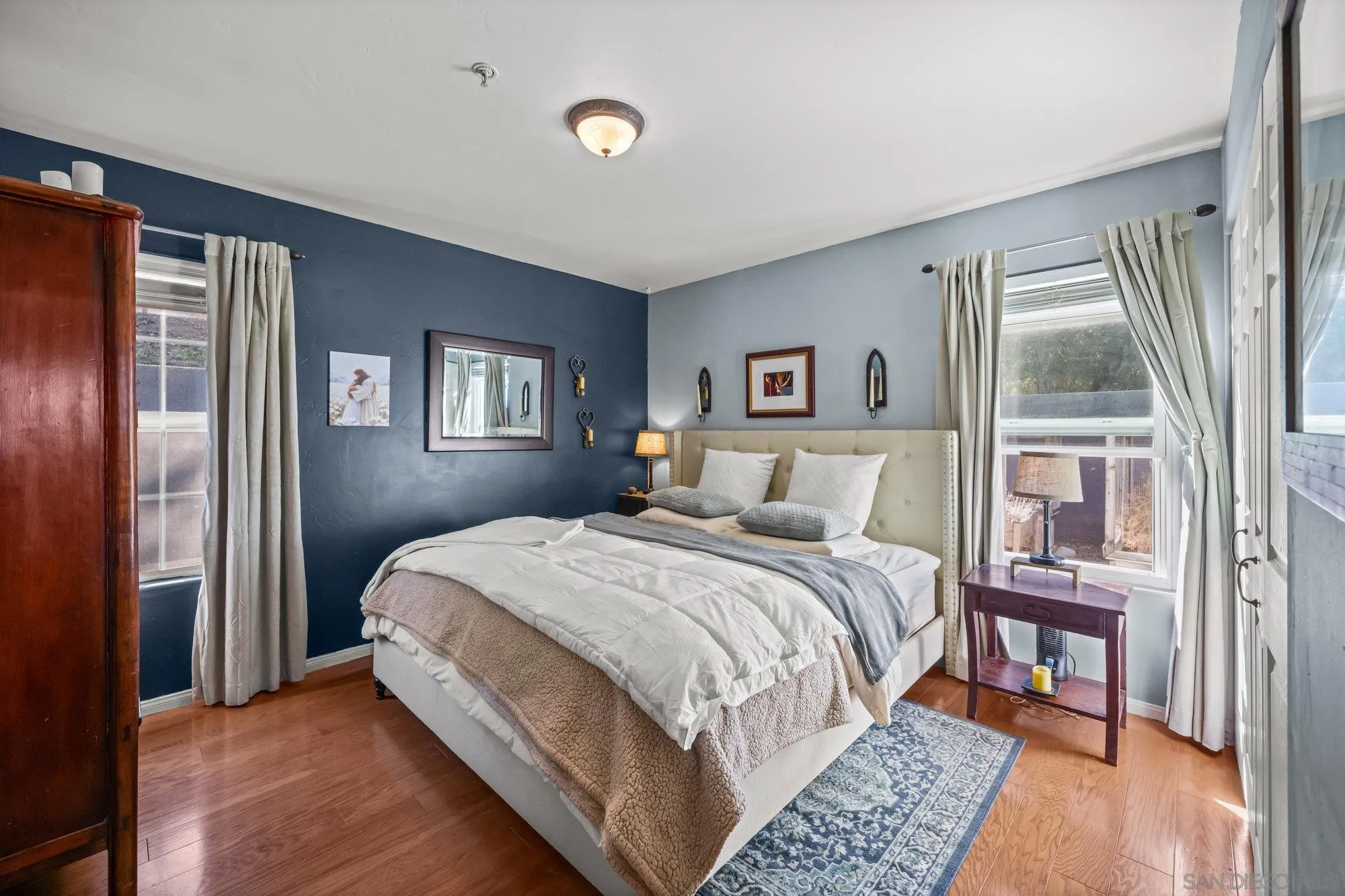 5058 Acorn Patch Road Julian, CA 92036 - Photo 14 of 31 a bed room with a bed and a painting