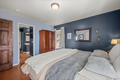 a bedroom with a large bed and a chandelier