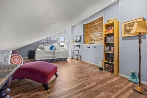 a bedroom with furniture and wooden floor