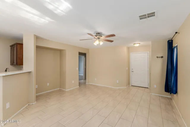 a view of an empty room with a ceiling fan