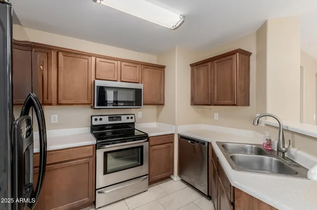 a kitchen with a sink stove and microwave