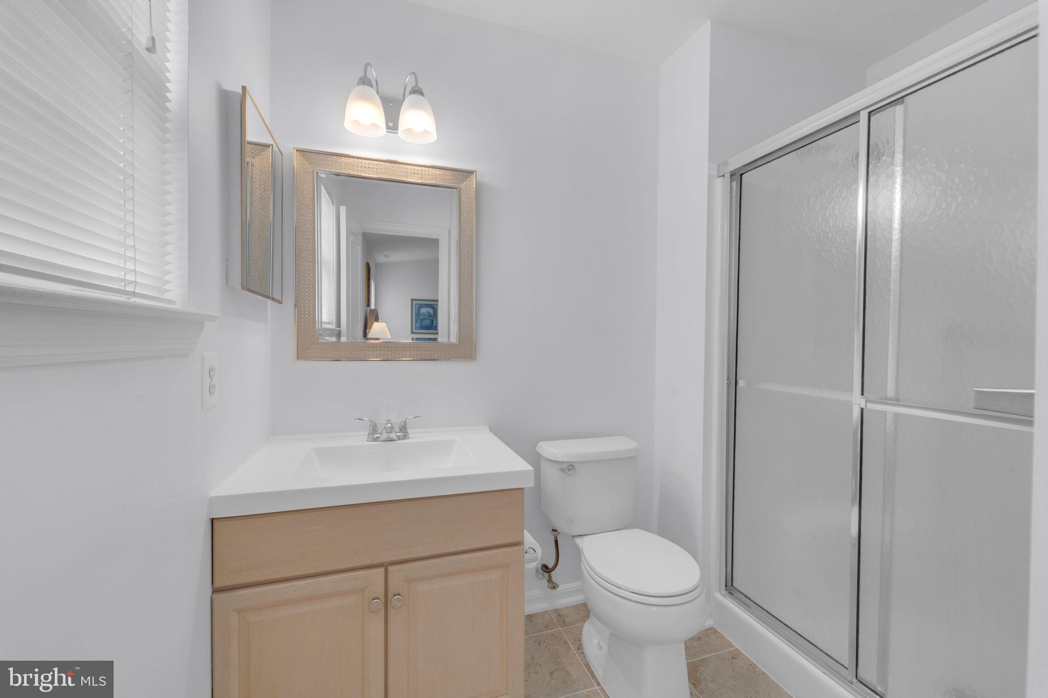 801 Freeport Way Williamstown, NJ 08094 - Photo 21 of 29 a bathroom with a toilet sink and mirror