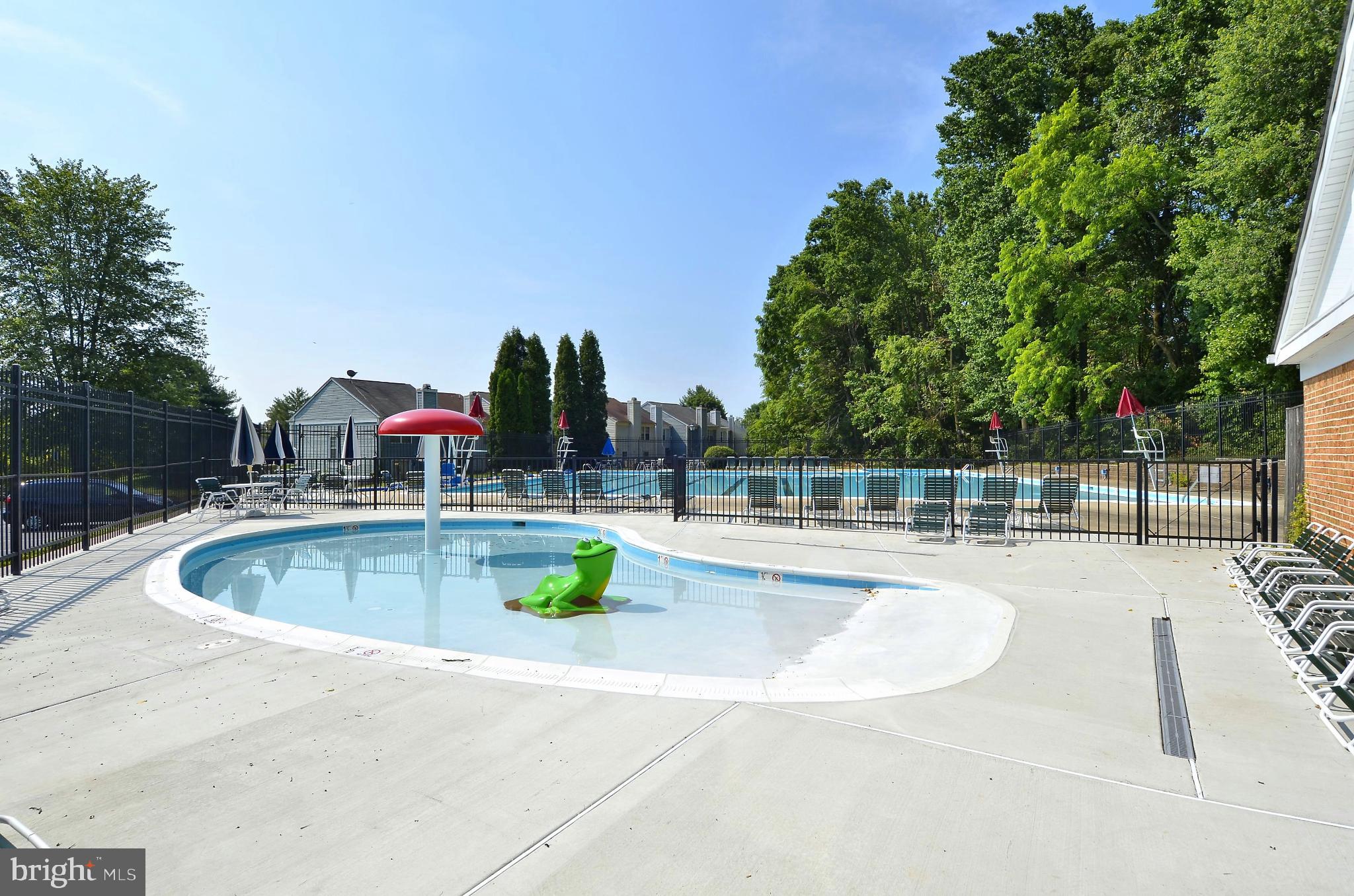 15129 Deer Valley Terrace Silver Spring, MD 20906 - Photo 21 of 30 Sunny poolside retreat with lush greenery.
