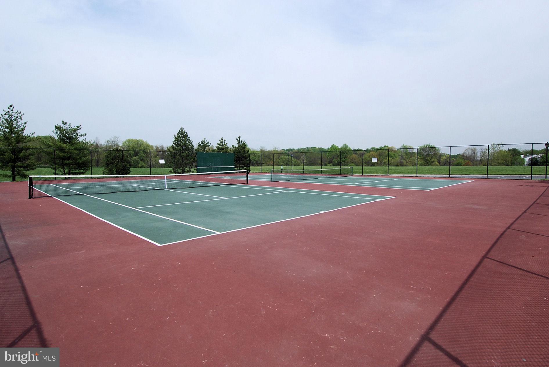 15129 Deer Valley Terrace Silver Spring, MD 20906 - Photo 25 of 30 Spacious tennis courts amidst lush greenery.