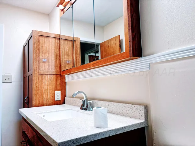 a bathroom with a sink and a mirror