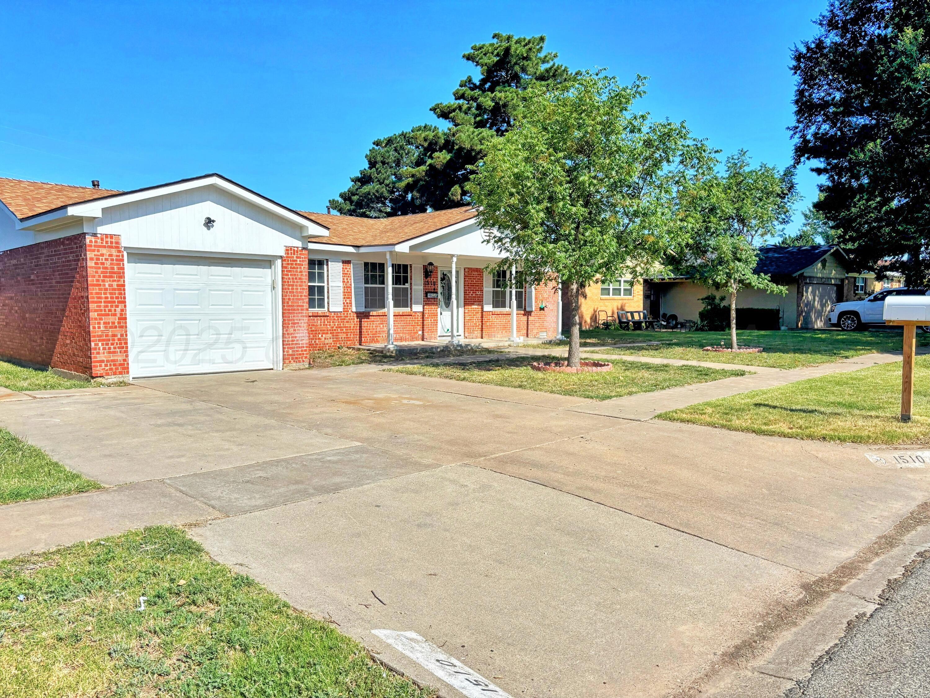 1510 South Indiana Street Perryton, TX 79070 - Photo 2 of 39 a front view of a house with a garden