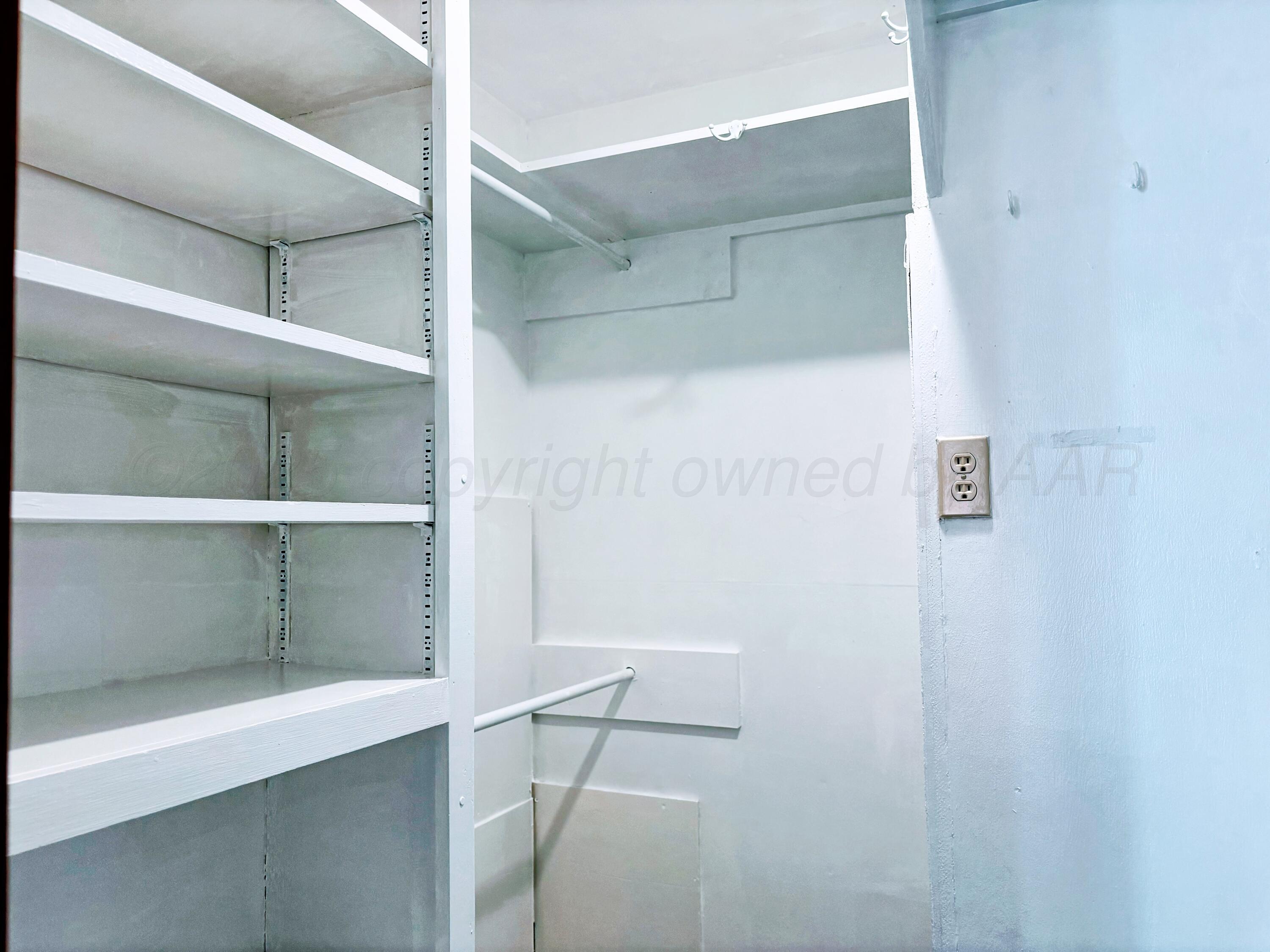 1510 South Indiana Street Perryton, TX 79070 - Photo 21 of 39 a view of storage and utility room with empty racks