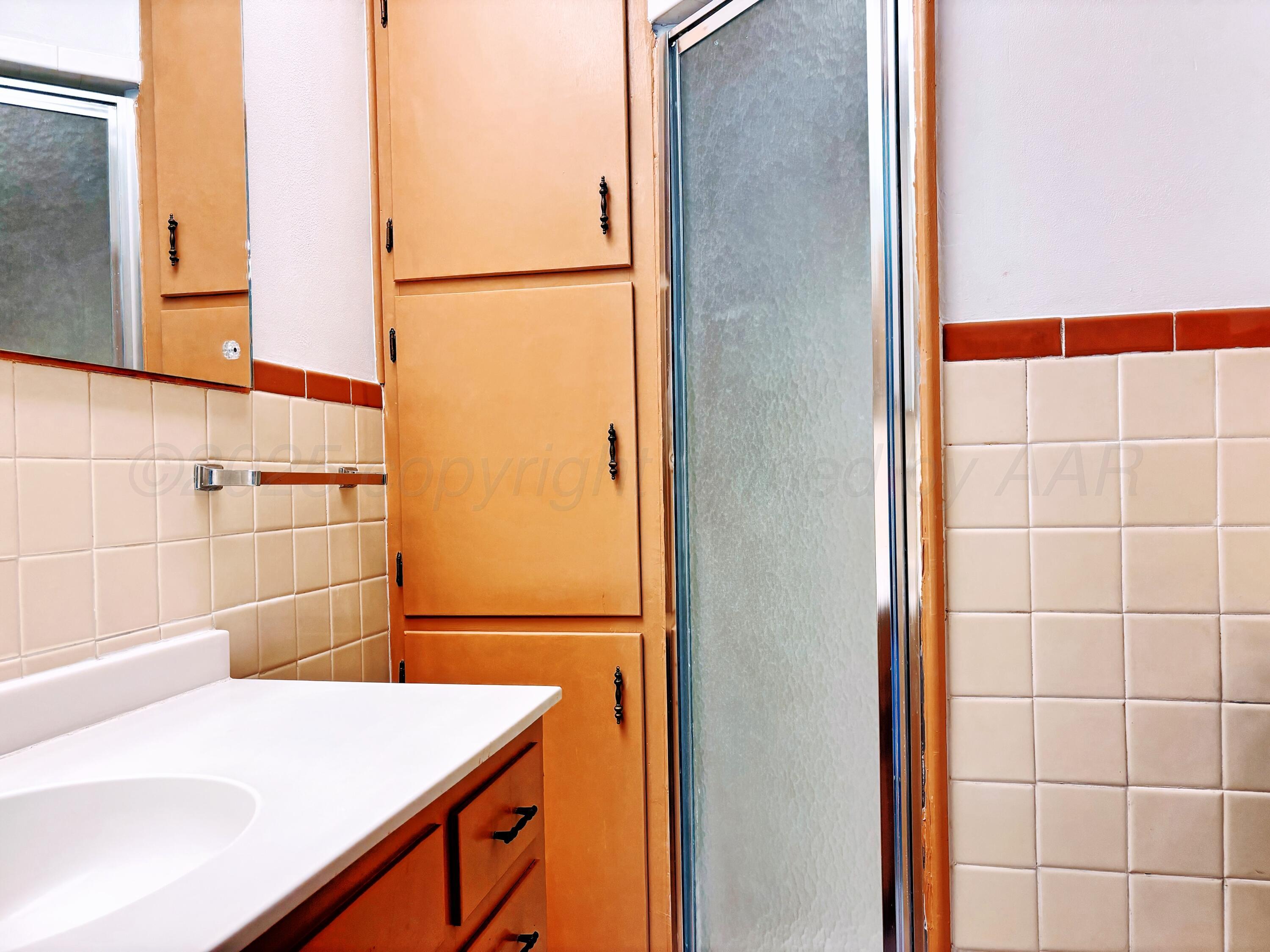1510 South Indiana Street Perryton, TX 79070 - Photo 22 of 39 a bathroom with a sink and a shower