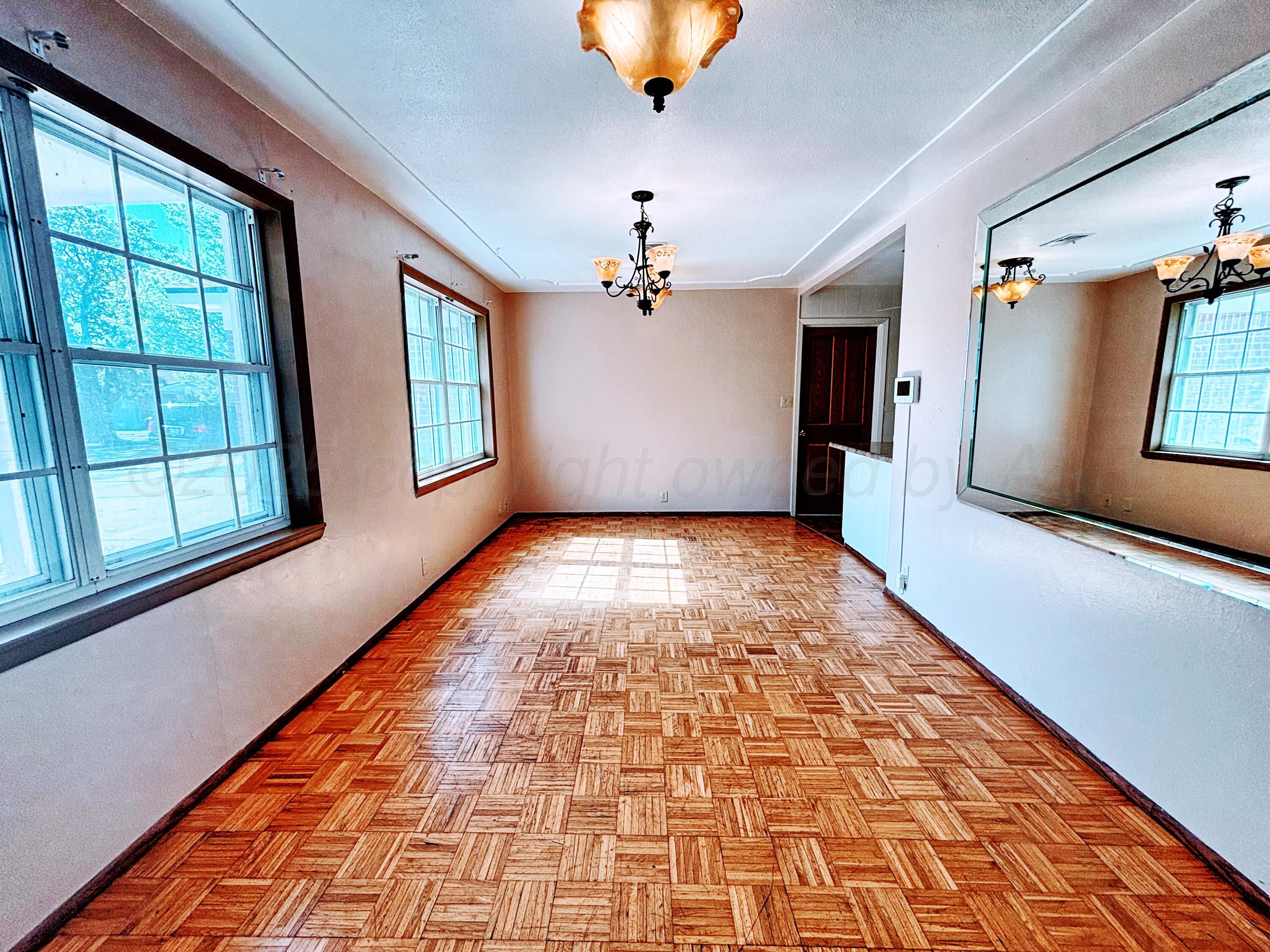 1510 South Indiana Street Perryton, TX 79070 - Photo 5 of 39 a view of empty room with windows