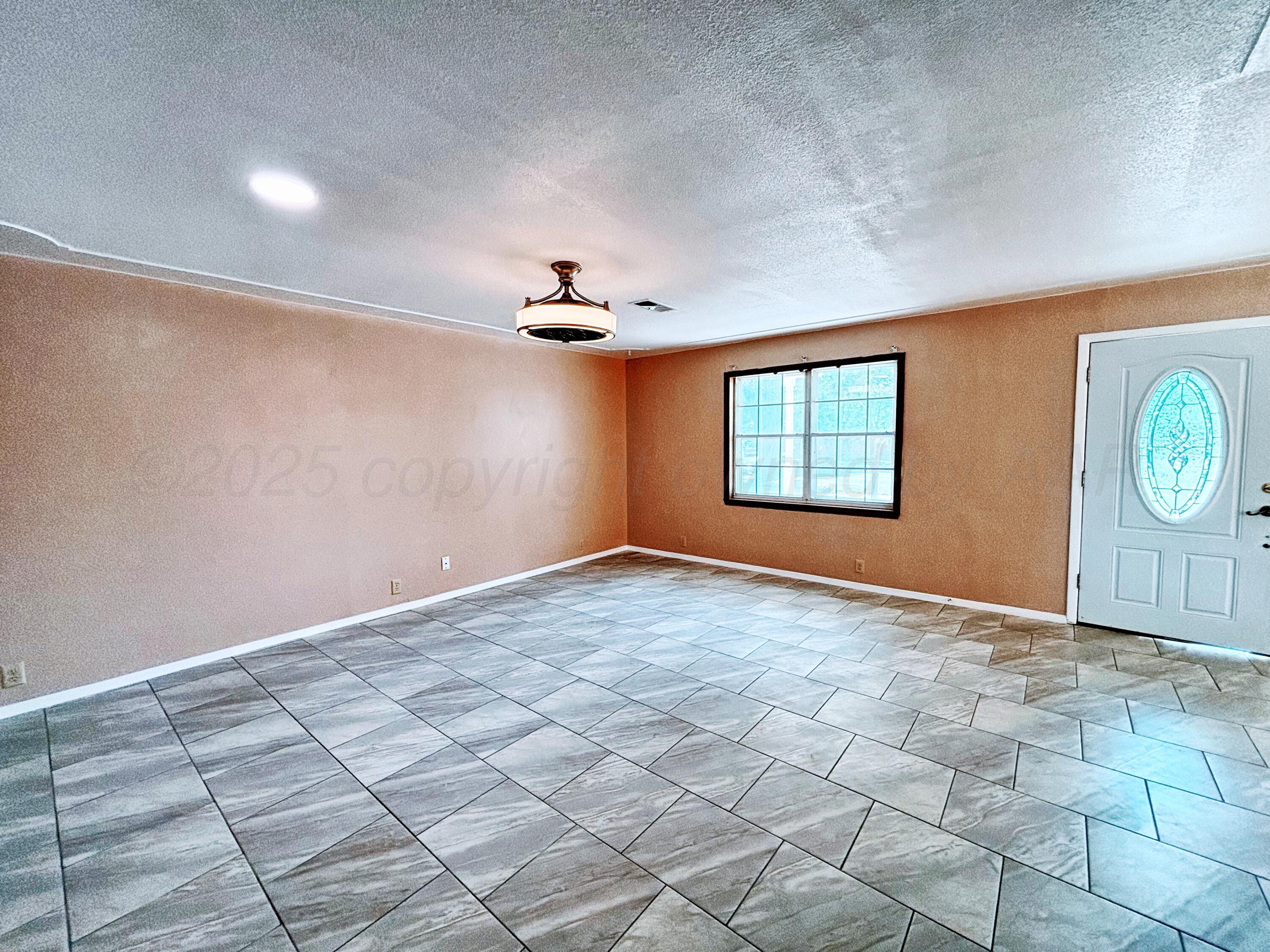 1510 South Indiana Street Perryton, TX 79070 - Photo 7 of 39 a view of a livingroom with a window