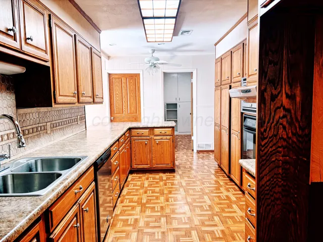 a kitchen with stainless steel appliances granite countertop a refrigerator and a stove
