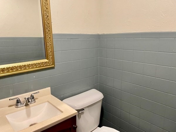 377 Park Avenue Worcester, MA 01610 - Photo 13 of 14 a bathroom with a sink a toilet and a mirror