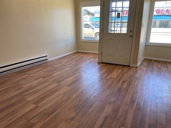 377 Park Avenue Worcester, MA 01610 - Photo 7 of 14 an empty room with wooden floor and windows