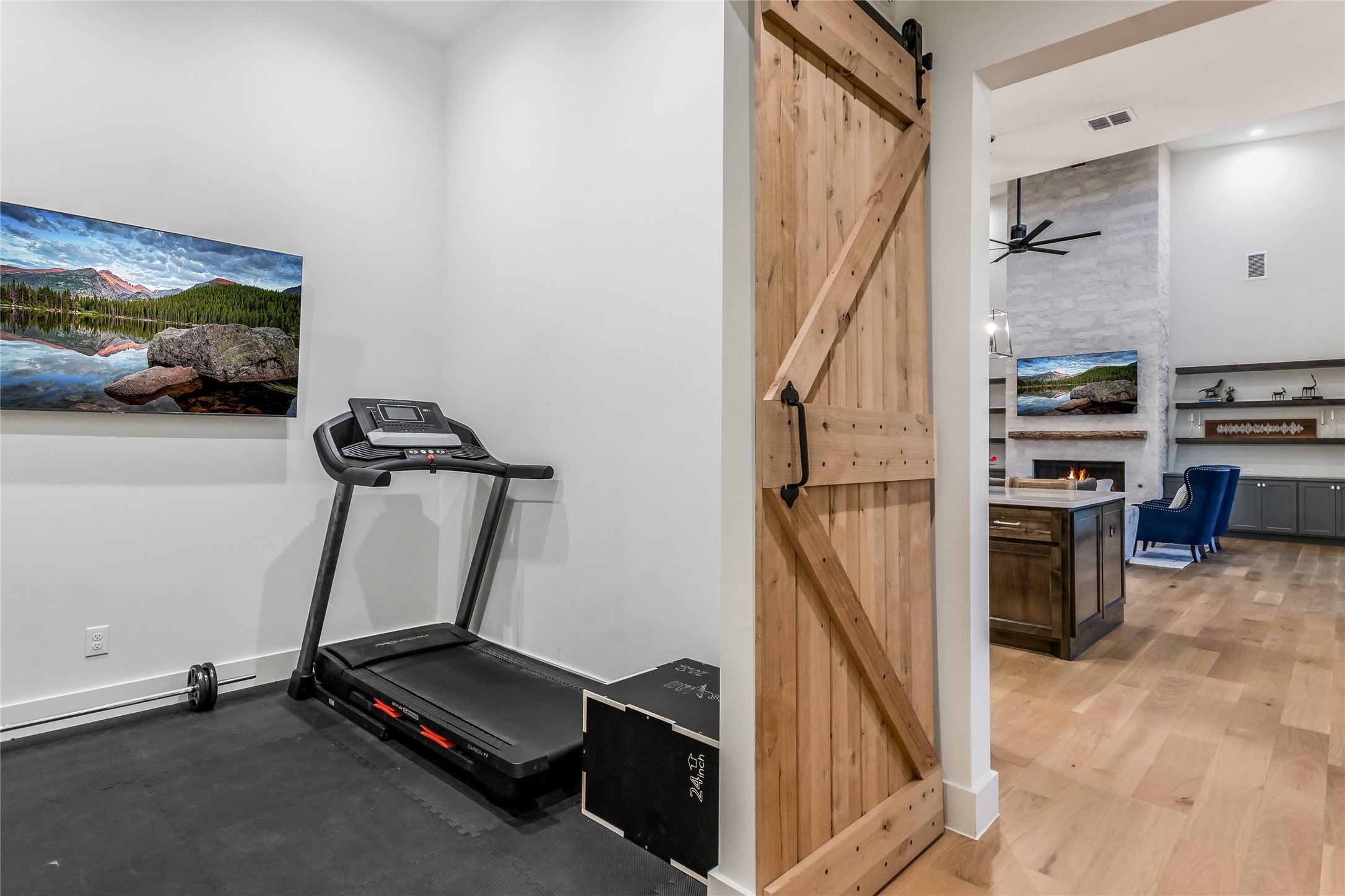 207 Gwendolyns Trail Wimberley, TX 78676 - Photo 7 of 40 a room with gym equipment and a view of kitchen